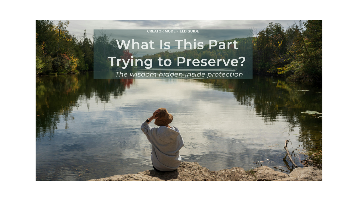 A person sits beside a peaceful river surrounded by trees, reflecting quietly while looking across still water. The image accompanies an article titled “What Is This Part Trying to Preserve? The wisdom hidden inside protection.”